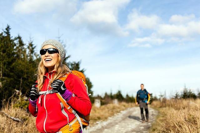 Two people walking on a country trail on a sunny day